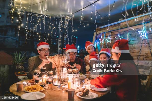 asian chinese siblings and friends preparing dinner during christmas celebration at front yard of the house - chinese family dinner stock pictures, royalty-free photos & images