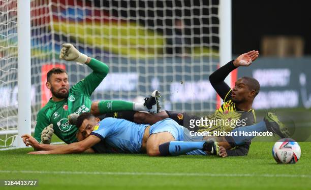 Ben Foster of Watford and Christian Kabasele of Watford collide with Maxime Biamou of Coventry City during the Sky Bet Championship match between...