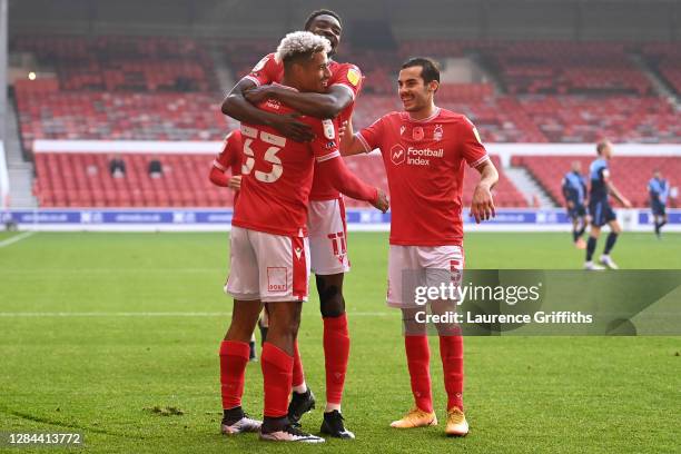 Lyle Taylor of Nottingham Forest celebrates with teammates after scoring his team's first goal during the Sky Bet Championship match between...