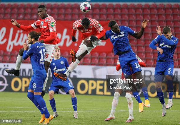 Matija Nastasic and Salif Sane of Schalke jump for a header with Jean-Philippe Mateta and Moussa Niakhate of Mainz during the Bundesliga match...