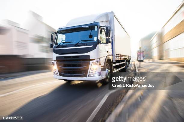 white truck in motion uk street - truck stock pictures, royalty-free photos & images
