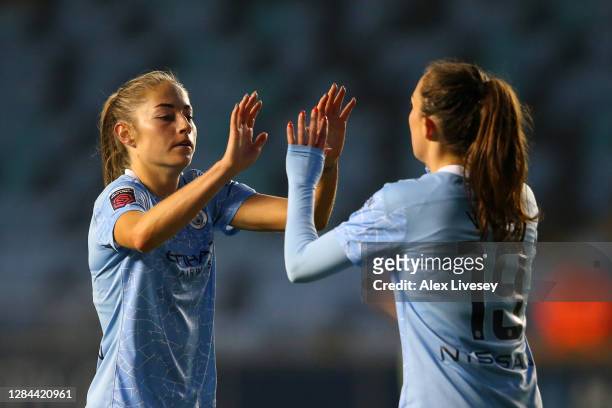Janine Beckie of Manchester City celebrates with teammate Caroline Weir after scoring her team's seventh goal during the Barclays FA Women's Super...