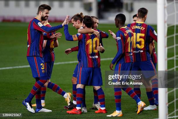 Lionel Messi of FC Barcelona celebrates with teammates after scoring his team's third goal during the La Liga Santander match between FC Barcelona...