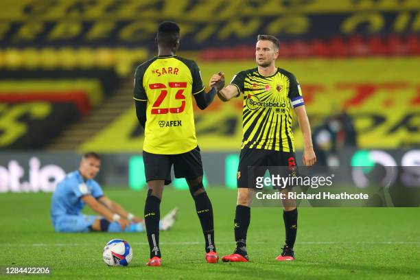 Ismaila Sarr and Tom Cleverley of Watford celebrate following their team's victory in the Sky Bet Championship match between Watford and Coventry...