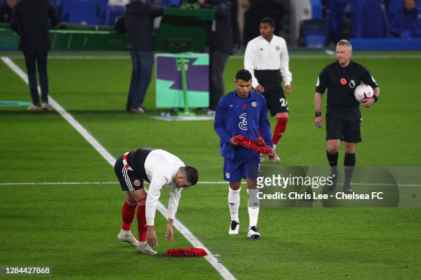 John Egan of Sheffield United and Thiago Silva of Chelsea lay Poppy Wreaths in the centre circle as both clubs pay respects to Armistice Day prior to...