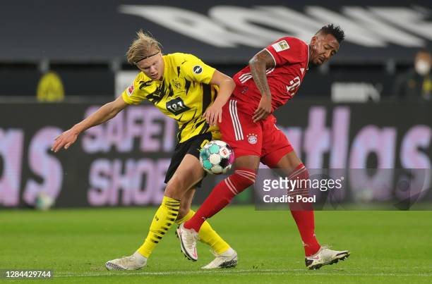 Erling Haaland of Dortmund is challenged by Jerome Boateng of Muenchen during the Bundesliga match between Borussia Dortmund and FC Bayern Muenchen...