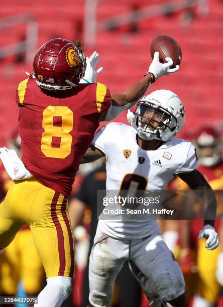 Amon-Ra St. Brown of the USC Trojans bobbles an imcomplete pass as Jack Jones of the Arizona State Sun Devils defends during the first half of a game...