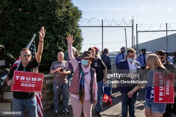 Supporters of President Donald Trump gather outside a press conference where attorney for the President, Rudy Giuliani spoke to the media in the back...