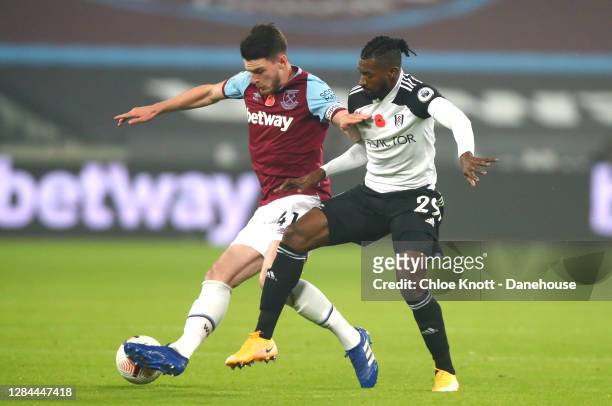 Declan Rice of West Ham United and Andre-Frank Zambo Anguissa of Fulham FC in action during the Premier League match between West Ham United and...