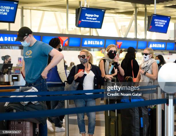 Air travelers check in for their flights in John F. Kennedy International Airport on November 07, 2020 in New York City. The global pandemic has had...