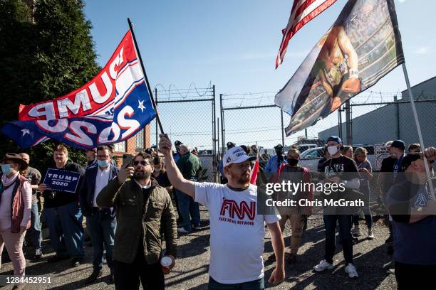 Supporters of President Donald Trump gather outside a press conference where attorney for the President, Rudy Giuliani spoke to the media in the back...