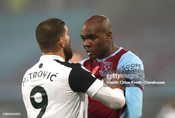Aleksandar Mitrovic of Fulham FC argues with Angelo Ogbonna of West Ham United during the Premier League match between West Ham United and Fulham at...