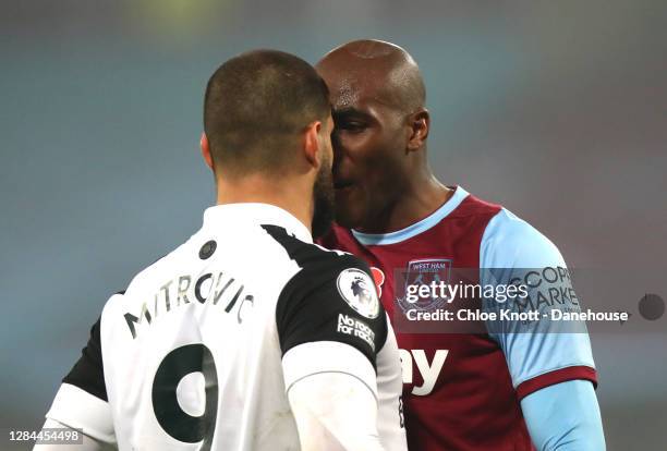 Aleksandar Mitrovic of Fulham FC argues with Angelo Ogbonna of West Ham United during the Premier League match between West Ham United and Fulham at...