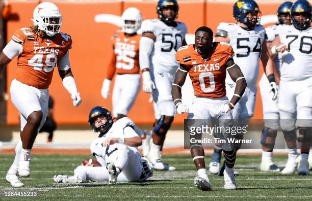 DeMarvion Overshown of the Texas Longhorns reacts after sacking Jarret Doege of the West Virginia Mountaineers in the third quarter at Darrell K...