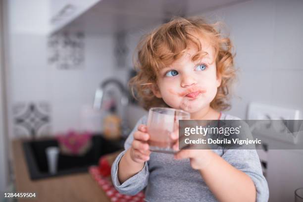 adorable happy child drinking chocolate milk - chocolate smoothie stock pictures, royalty-free photos & images