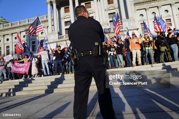 Hundreds of people for and against Donald Trump, some of them armed, gather in the state capital of Pennsylvania to display their anger at the...