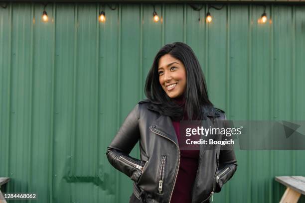 紐約上州綠牆外穿皮夾克的亞裔美國婦女肖像 - straight hair 個照片及圖片檔