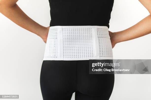 pregnant woman in support bandage medical corset close up. rear view unrecognisable person. - orthopedic corset stock pictures, royalty-free photos & images