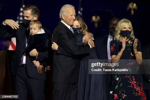President-elect Joe Biden gets a hug from his grand daughter on stage after Biden's address to the nation from the Chase Center November 07, 2020 in...