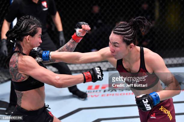 Yan Xiaonan of China punches Claudia Gadelha of Brazil in a strawweight fight during the UFC Fight Night event at UFC APEX on November 07, 2020 in...