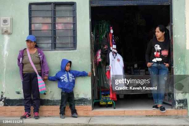 Indigenous Páez people, also known as the Nasa stand in front of a store on the side of the main square enjoying peace and tranquility after signing...