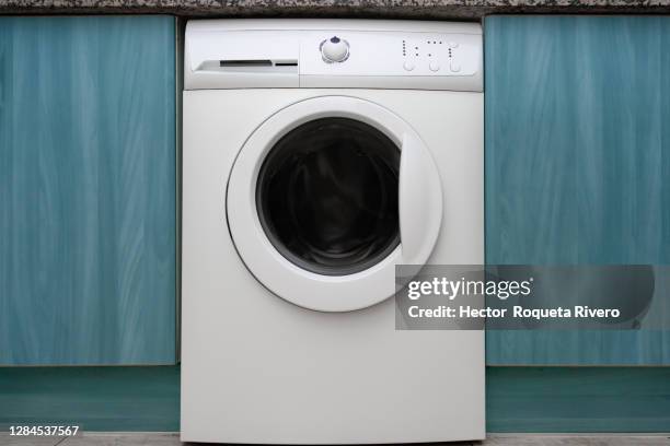 unbranded white washing machine with green and blue furniture - washing machine front stock pictures, royalty-free photos & images