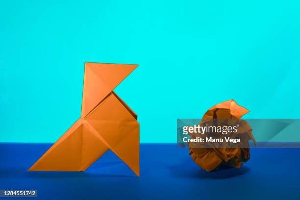 paper figure of a bird and a paper ball - stock photo - pajarita foto e immagini stock
