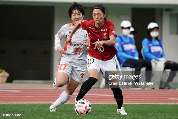 Ayaka Osajima of Ehime FC Ladies and Kozue Ando of Urawa Red Diamonds compete for the ball during the Nadeshiko League match between Urawa Red...