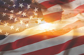 America USA flag transparent over the sunset dawn refer to the hope for American people of the national business world