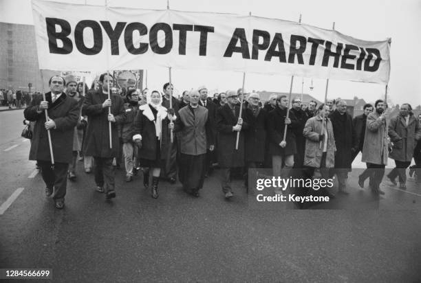 Anti-apartheid marchers carrying a banner reading 'Boycott Apartheid' marching to Twickenham rugby ground where England are playing South Africa, in...