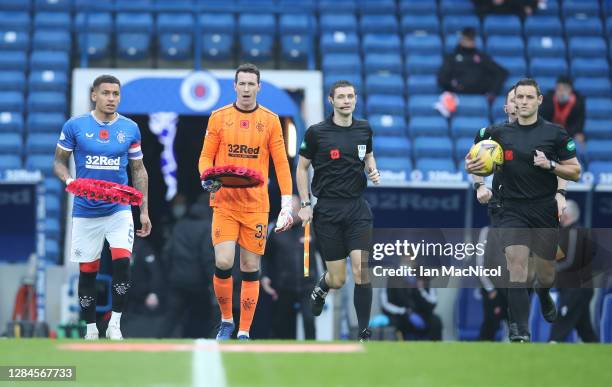 Filip Helander and Jon McLaughlin of Rangers carry Armistice Day poppy wreathes onto the pitch prior to the Ladbrokes Scottish Premiership match...