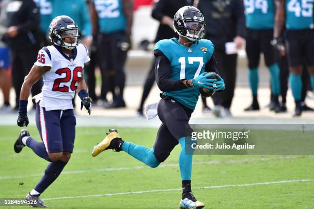 Chark of the Jacksonville Jaguars catches a pass for a touchdown in front of Michael Thomas of the Houston Texans during the first quarter of a game...