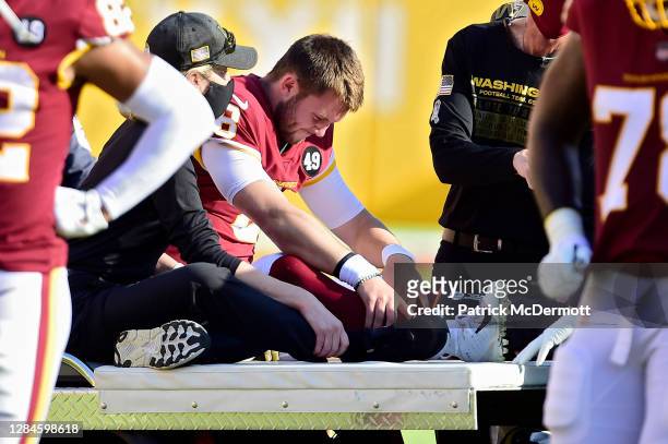 Kyle Allen of the Washington Football Team is carted off the field after being injured in the first quarter against the New York Giants at FedExField...