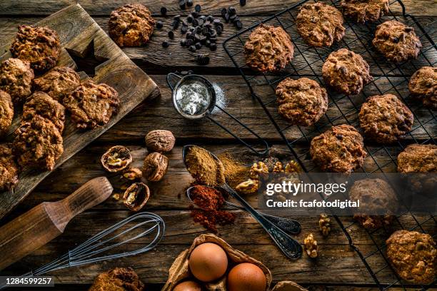 chocolate chip cookies on rustic kitchen table - walnut cookie stock pictures, royalty-free photos & images