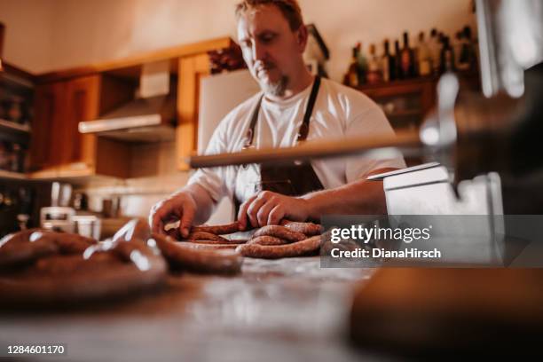 mature mean makes his own german sausages at home - charcuterie stock pictures, royalty-free photos & images