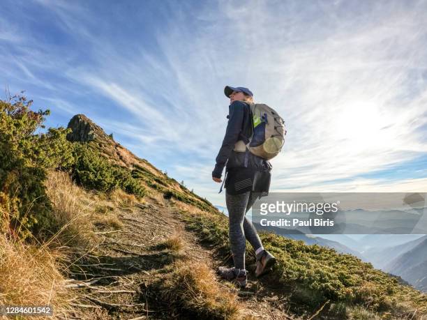 woman with backpack hiking in carpathian mountains - beautiful romanian women stock pictures, royalty-free photos & images