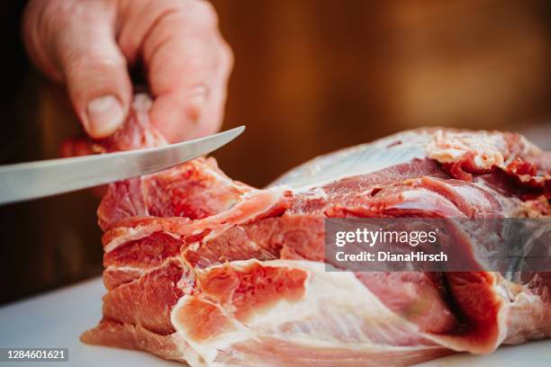 close-up of male hands cutting carefully the tendons from the beef - tendon stock pictures, royalty-free photos & images