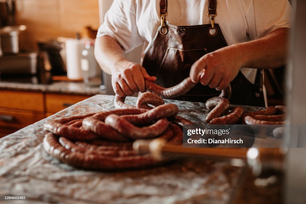 Man preparing his own homemade sausages at home