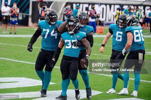 James Robinson of the Jacksonville Jaguars celebrates with teammates after rushing for a touchdown during the first half against the Houston Texans...