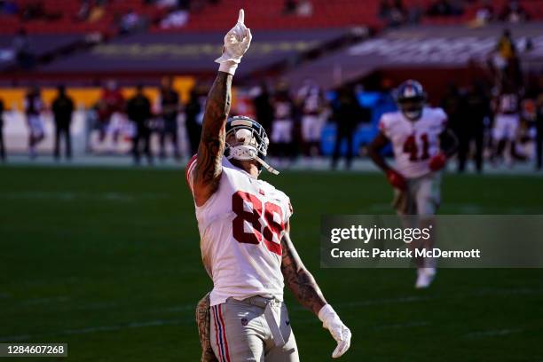 Evan Engram of the New York Giants celebrates after scoring a touchdown in the second quarter against the Washington Football Team at FedExField on...