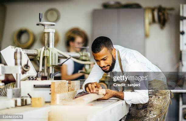 two carpenters at work - black sculptor stock pictures, royalty-free photos & images