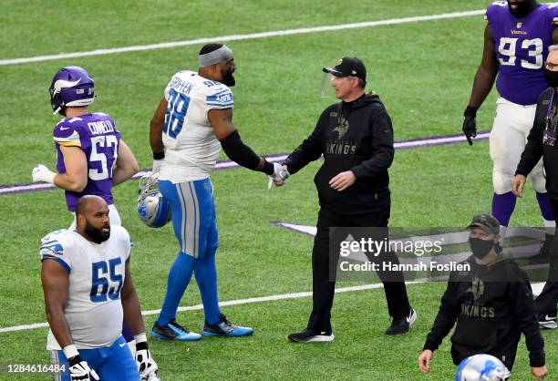 Minnesota Vikings head coach Mike Zimmer shakes hands with Everson Griffen of the Detroit Lions after their game at U.S. Bank Stadium on November 08,...