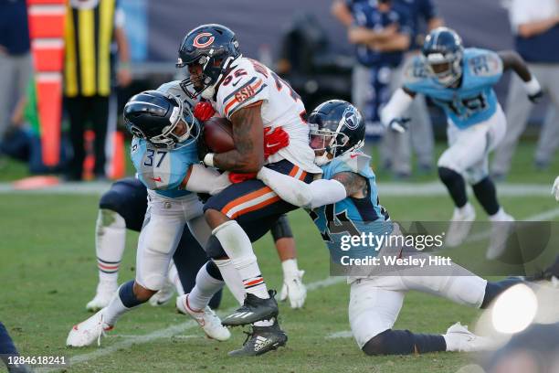 Amani Hooker and Kenny Vaccaro of the Tennessee Titans combine on David Montgomery of the Chicago Bears during the fourth quarter at Nissan Stadium...