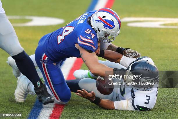 Russell Wilson of the Seattle Seahawks fumbles after being sacked by A.J. Klein of the Buffalo Bills during the second half at Bills Stadium on...