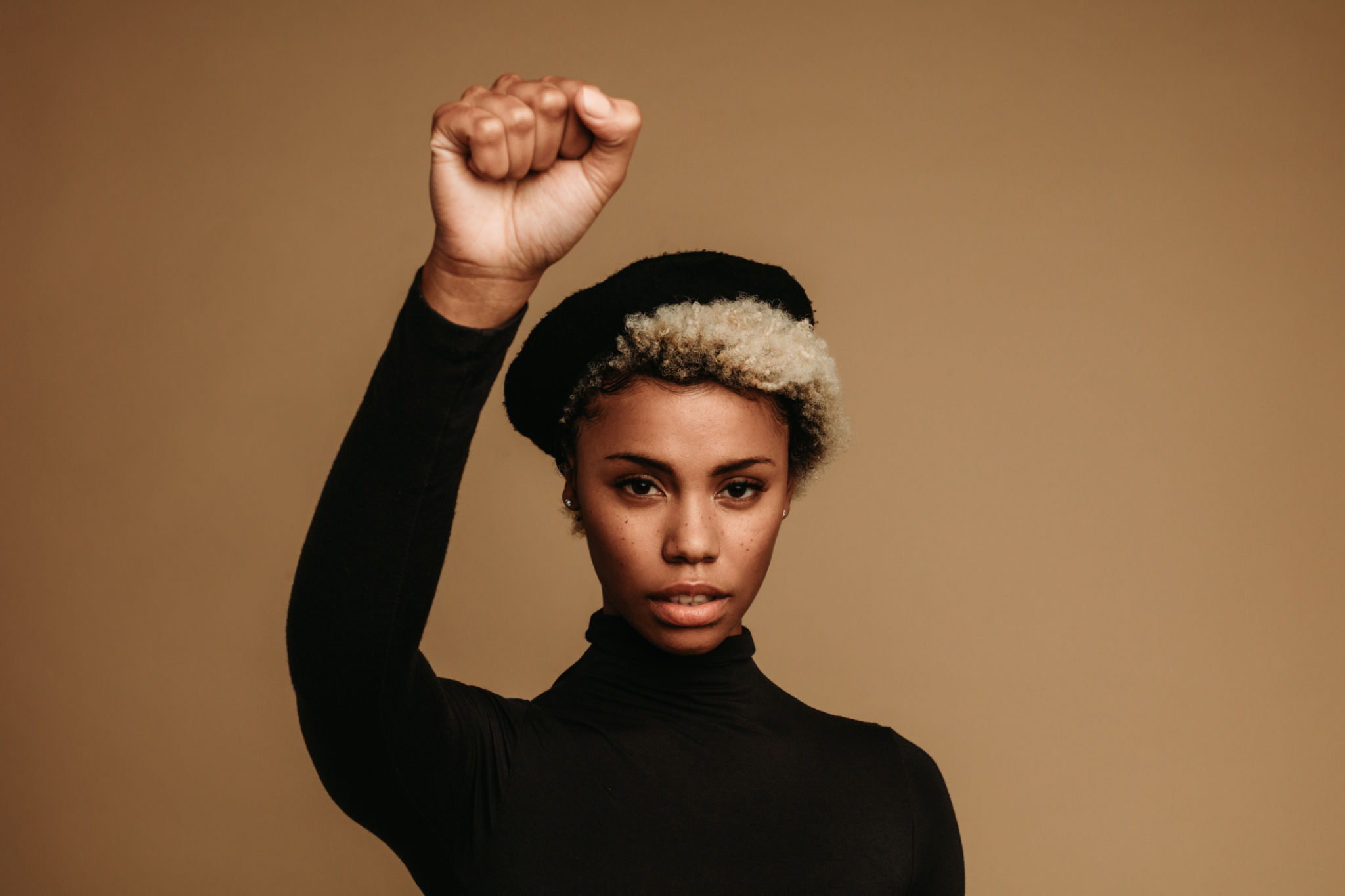 Close up of african american woman with raised fist Close up of african american woman with raised fist