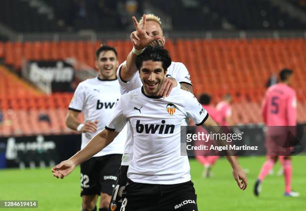 Carlos Soler of Valencia celebrates with teammate Uroc Racic after scoring his team's fourth goal during the La Liga Santander match between Valencia...