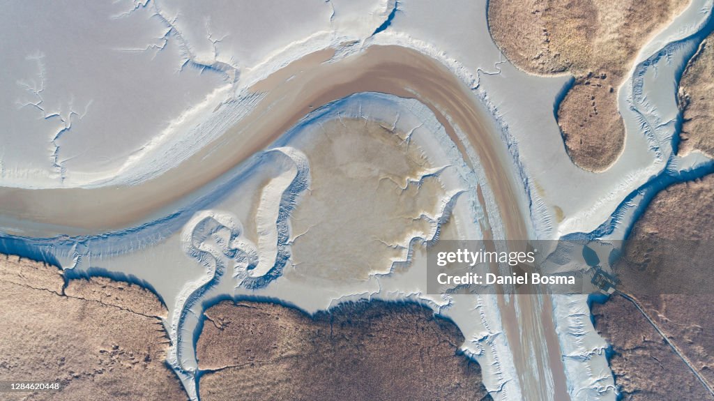 Aerial view of amazing natural shapes and patterns exposed during low tide along the Dutch northcoast