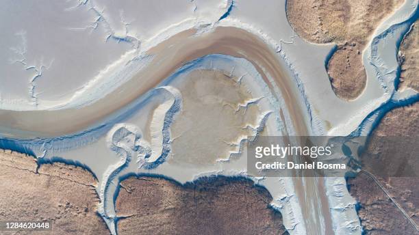 aerial view of amazing natural shapes and patterns exposed during low tide along the dutch northcoast - low tide stock pictures, royalty-free photos & images