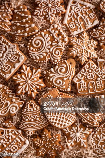 christmas gingerbread cookies on holiday packaging. homemade cookies. - gingerbread house cookie stock pictures, royalty-free photos & images
