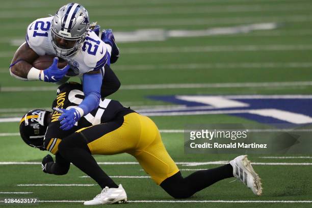 Ezekiel Elliott of the Dallas Cowboys is brought down by Steven Nelson of the Pittsburgh Steelers at AT&T Stadium on November 08, 2020 in Arlington,...